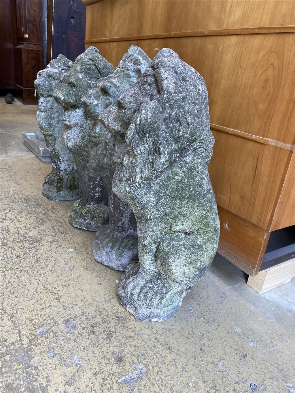 A set of four reconstituted stone lion garden ornaments, height 52cm